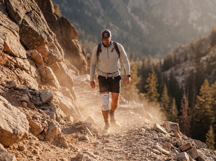Hiker on a steep, rocky, uneven descent